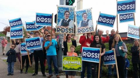 Supporters of Marco Rossi waving signs.